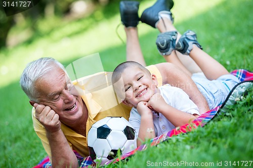 Image of grandfather and child have fun  in park