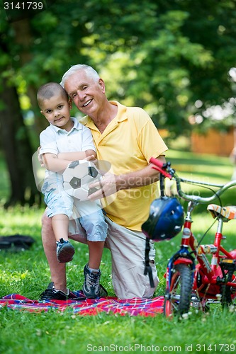 Image of grandfather and child have fun  in park