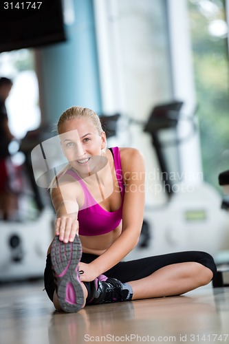 Image of woman stretching and warming up for her training at a gym