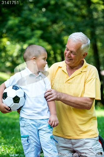 Image of grandfather and child have fun  in park