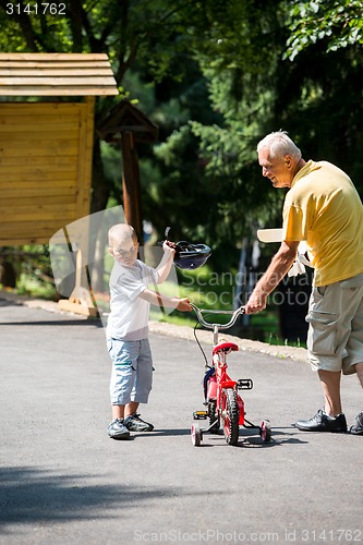 Image of grandfather and child have fun  in park