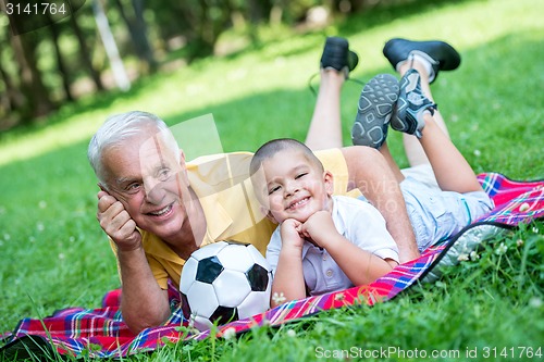 Image of grandfather and child have fun  in park