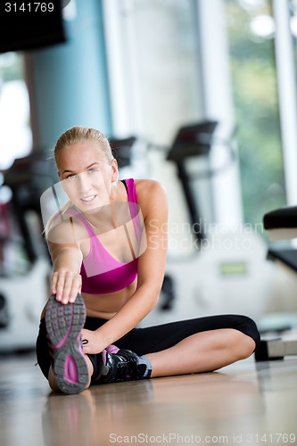 Image of woman stretching and warming up for her training at a gym