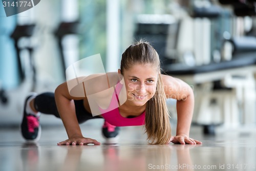 Image of warming up and doing some push ups a the gym