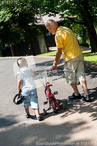 Image of grandfather and child have fun  in park