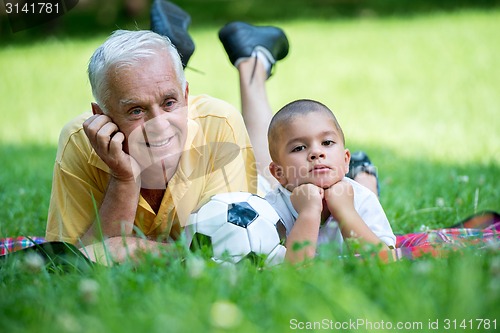 Image of grandfather and child have fun  in park