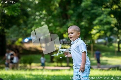 Image of boy with airpane toy