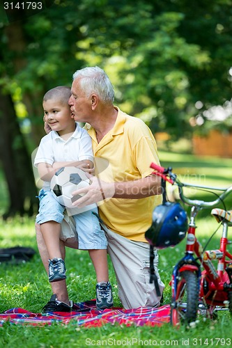 Image of grandfather and child have fun  in park
