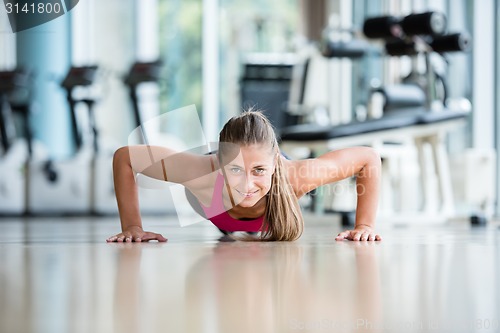 Image of warming up and doing some push ups a the gym