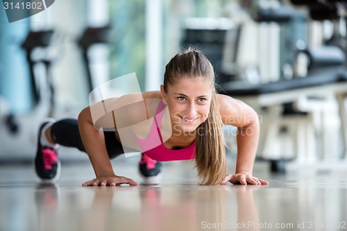 Image of warming up and doing some push ups a the gym