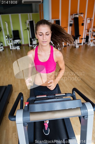 Image of woman exercising on treadmill in gym