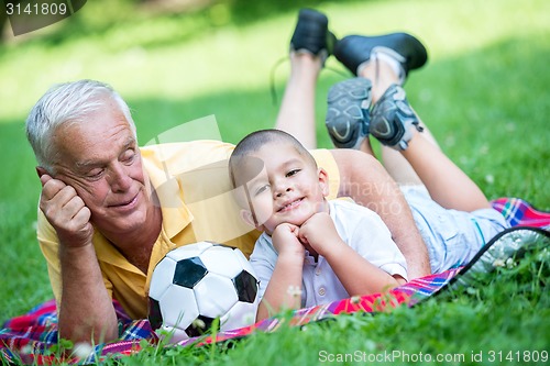 Image of grandfather and child have fun  in park