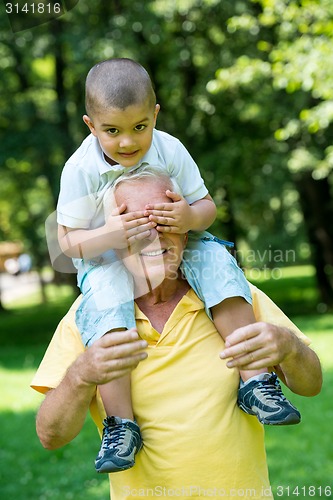 Image of grandfather and child have fun  in park