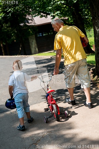 Image of grandfather and child have fun  in park