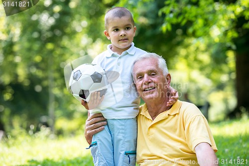 Image of grandfather and child have fun  in park