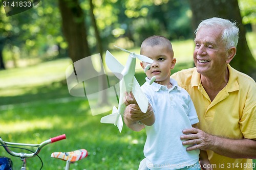 Image of grandfather and child have fun  in park