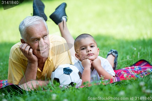 Image of grandfather and child have fun  in park