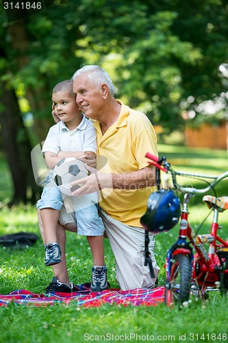 Image of grandfather and child have fun  in park