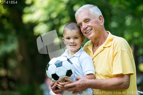 Image of grandfather and child have fun  in park