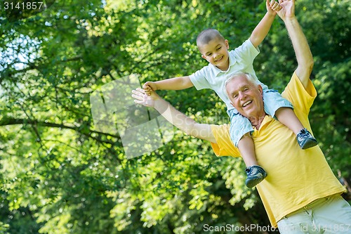 Image of grandfather and child have fun  in park