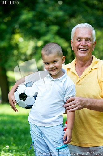 Image of grandfather and child have fun  in park