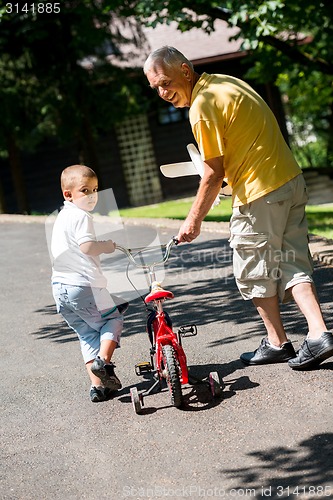 Image of grandfather and child have fun  in park