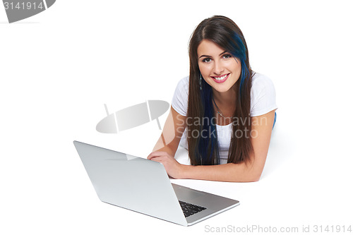 Image of Woman lying on the floor with laptop