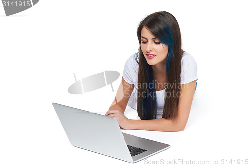 Image of Woman lying on the floor with laptop