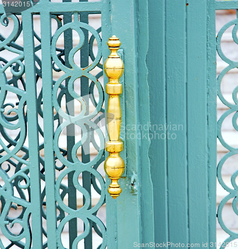Image of blue metal rusty  brown    morocco in africa  gold padlock 