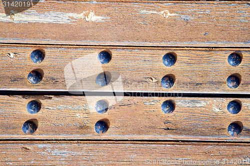 Image of nail dirty stripped paint in   brown wood  