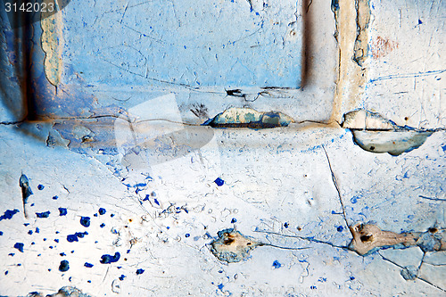 Image of dirty stripped  in   blue  door and rusty  