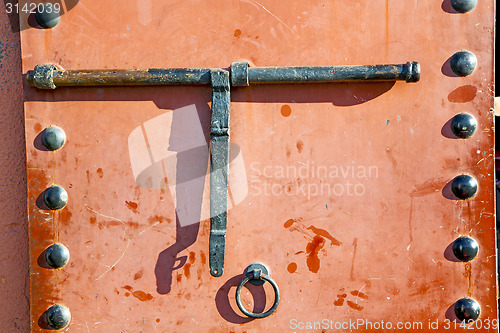 Image of metal rusty  brown    morocco in  red  facade home and 