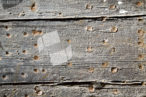 Image of nail dirty stripped paint in   wood  and rusty red