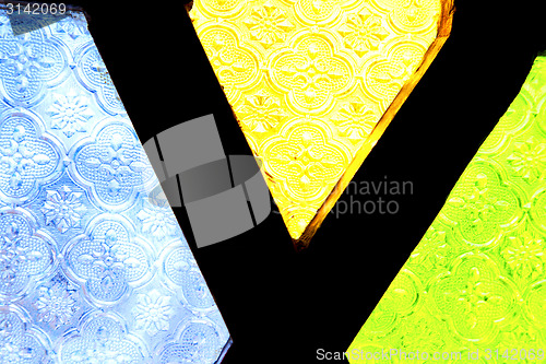 Image of colorated glass and sun in   window and light