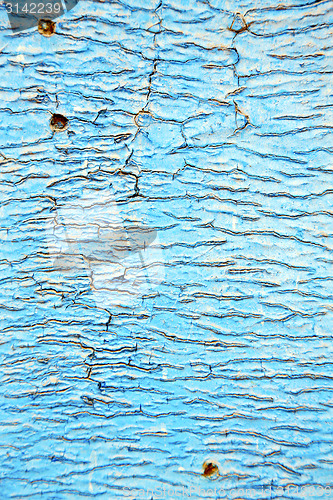 Image of dirty  paint in the blue wood  rusty nail