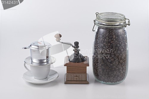 Image of Vietnam style coffee and manual grinder and coffee bean