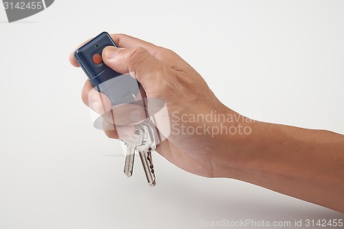 Image of Hand press the remote control with keys