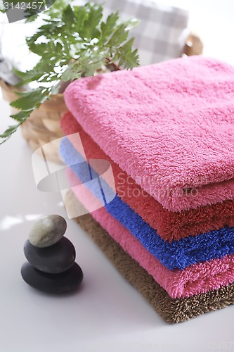 Image of Towel and stone with relaxing setting