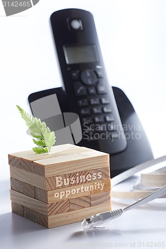 Image of Black telephone with 3d puzzle and network cable
