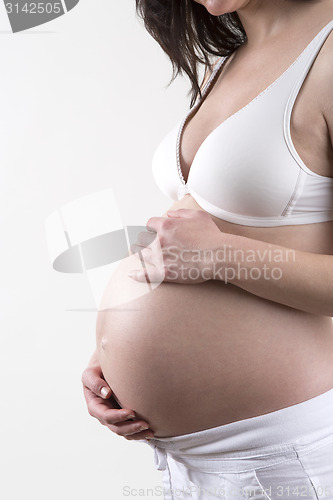 Image of Pregnant woman in front of a white background