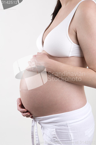 Image of Pregnant woman in front of a white background
