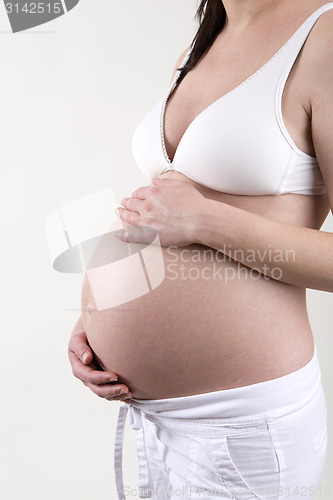 Image of Pregnant woman in front of a white background