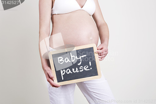 Image of Pregnant woman with an empty blackboard