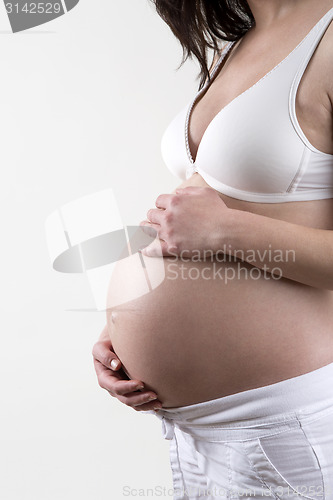 Image of Pregnant woman in front of a white background