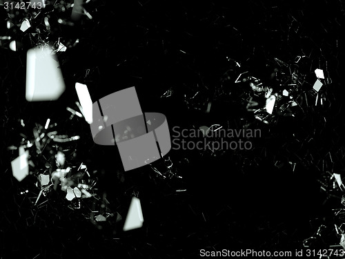 Image of Pieces of splitted or cracked glass on black in the dark