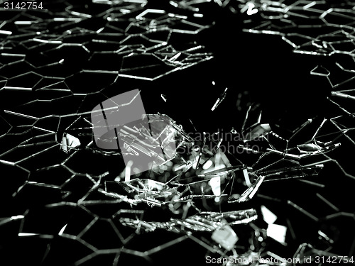 Image of Destructed and splitted glass pieces on black 