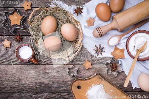 Image of Christmas homemade cookies and ingredients on wood