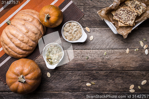 Image of Rustic pumpkins with cookies and seeds on wood