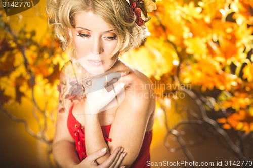 Image of Magic gold autumn blonde girl portrait in leafs