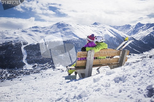 Image of Young couple hugging ski resort winter mountains